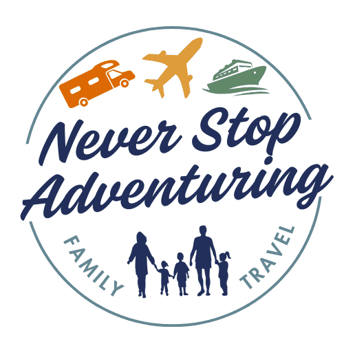 Logo for the family travel blog “Never Stop Adventuring,” featuring a silhouette of a family with icons of an RV, airplane, and cruise ship above the name. The words “Family Travel” frame the bottom of the circular design.